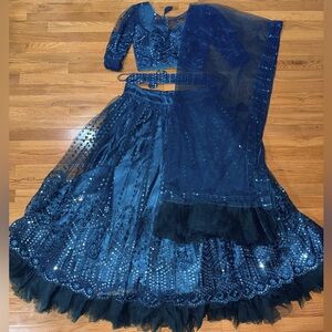 Blue two piece choli that is long sleeved and comes with dupatta.